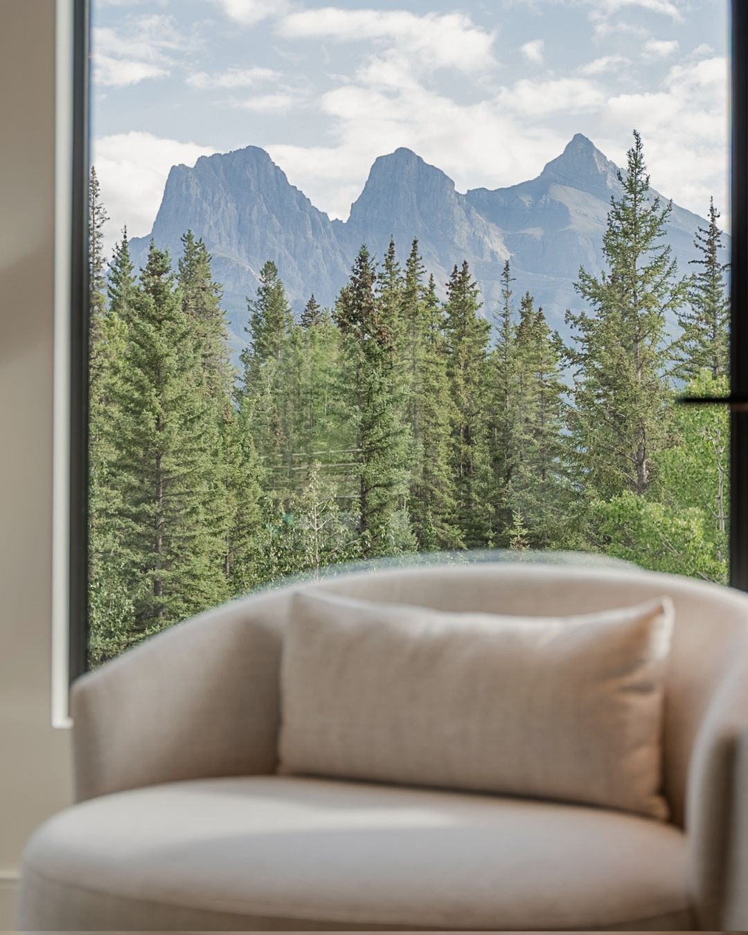 A chair at the window, the Three Sisters beyond