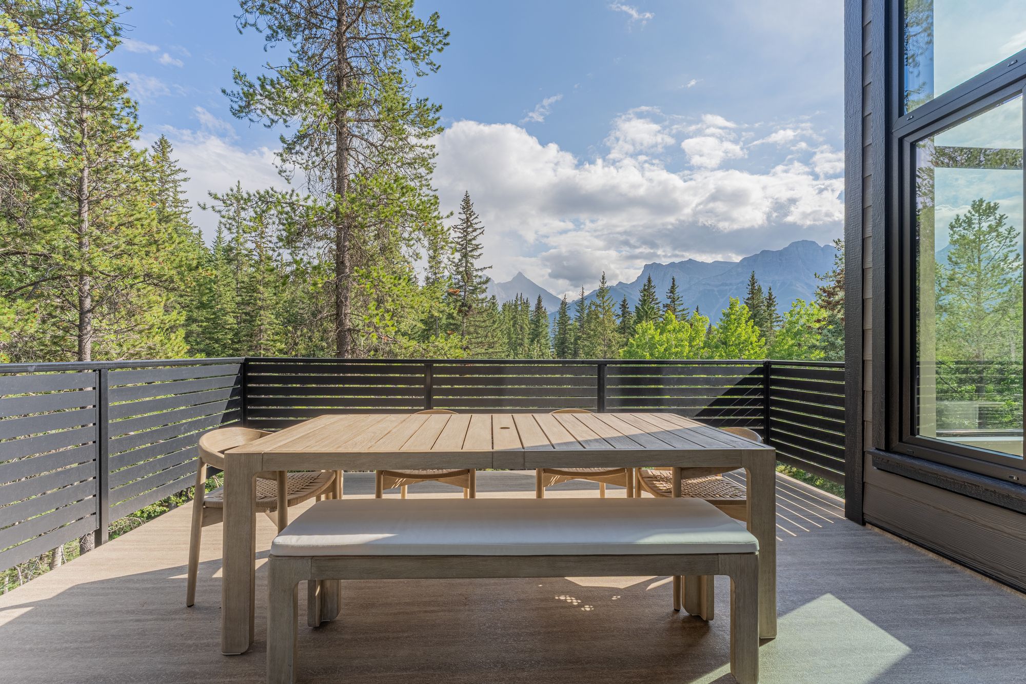 The table on the deck, the peaks over the trees