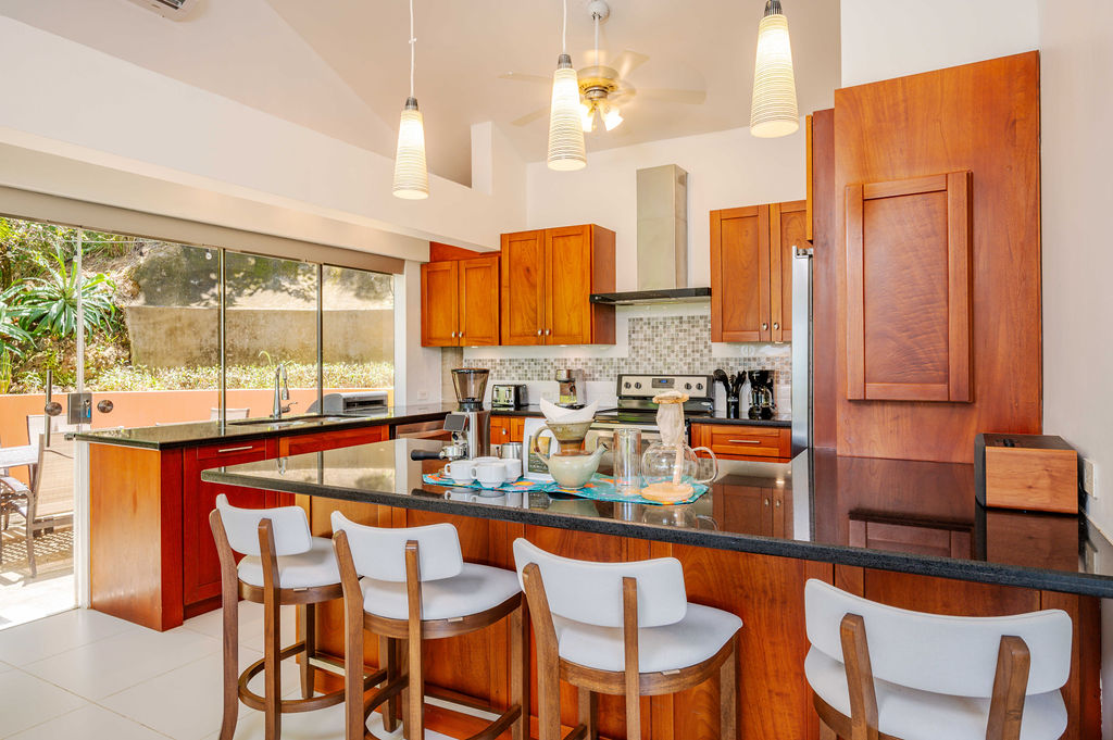 Kitchen with wooden cabinetry and bar seating