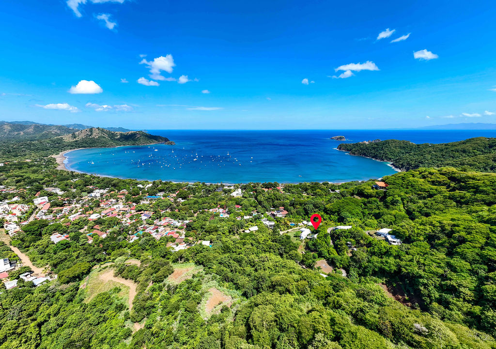 Wide aerial of Playas del Coco bay and the surrounding hills